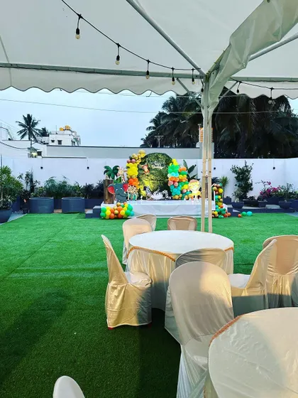 The seating arrangement for a birthday party, with the themed stage visible in the background.