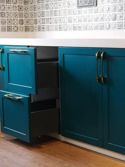 A detail shot of the internal drawers within a larger cabinet. This two-drawer system provides layered storage, perfect for separating different types of kitchen tools or linens.