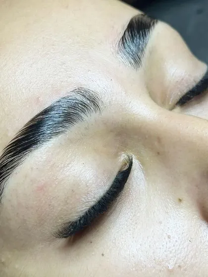 The view from the lash bed. Perfectly laminated brows and a dense lash line, ready to go.