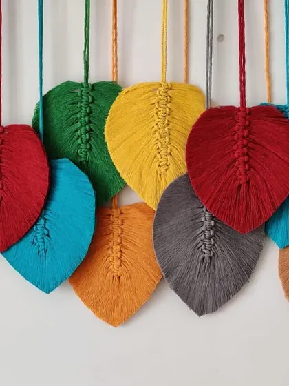 The rich red, blue, and grey leaves in this wall art create a beautiful contrast.
