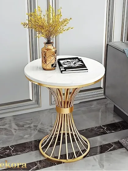 This elegant side table showcases a sculptural wireframe base with a cinched waist design, finished in gold. The round marble-finish top makes it a sophisticated accent piece for any modern or classic interior.