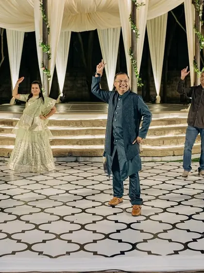 Family members enjoying the Sangeet performances, their faces full of joy and excitement.