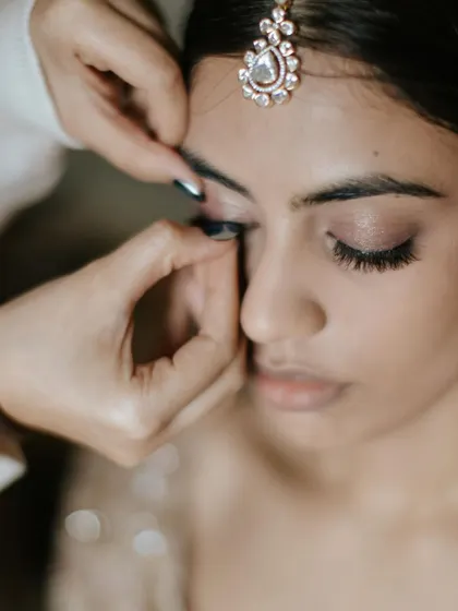 A behind-the-scenes look at applying lashes. This is a key step to define the eyes while still keeping the look soft and natural.