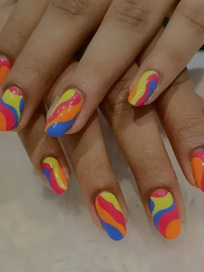 A vibrant and playful retro-inspired design with colorful waves of yellow, orange, blue, and pink.