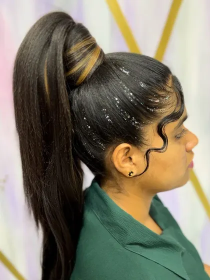 A sleek, high ponytail with perfectly styled baby hair and a touch of glitter. This is a bold, high-fashion look.