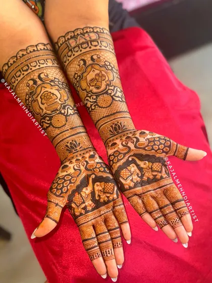 A beautiful bridal design featuring auspicious elephants on the palms and intricate floral motifs on the arms.