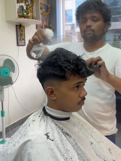 Prepping the hair with a water spray before cutting. This helps me achieve cleaner sections and more precise lines.