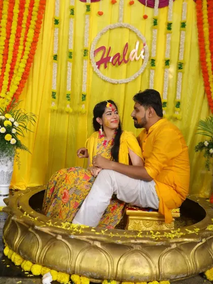 The couple seated in a beautiful lotus-shaped 'urli' for their Haldi ceremony. We work with decorators to create stunning and unique setups for your events.