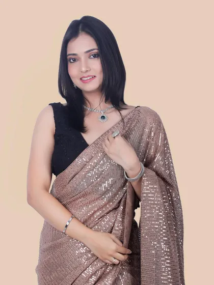 A classic and happy portrait of a model wearing a traditional saree and jewelry, ideal for showcasing festive or celebratory wear.