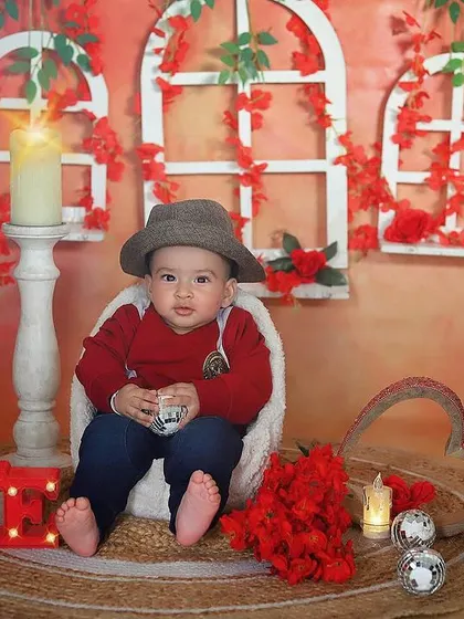 A cool little dude in our Valentine's setup. The red accents, glowing "LOVE" sign, and his stylish hat create a fun and charming look for this sitter session.