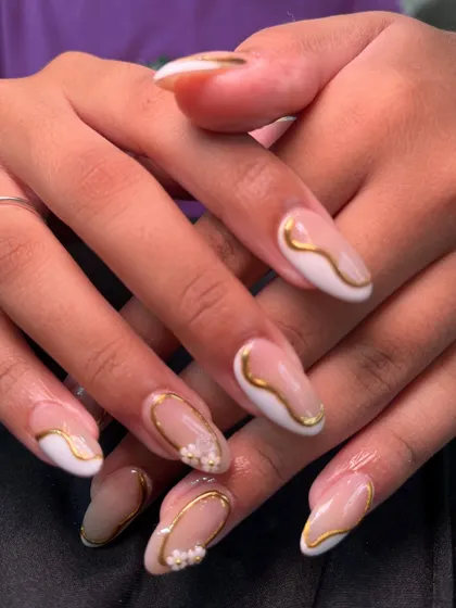 Perfect for the festive season, this design features a modern French tip outlined in gold. I added delicate, 3D white flowers on the accent nails for a look that is both celebratory and elegant.