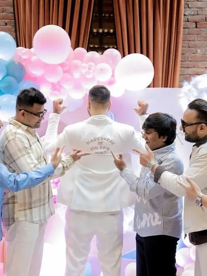 The dad-to-be showing off his custom 'Daddy Cool Est. 2023' jacket, a fun, personal touch we arranged.