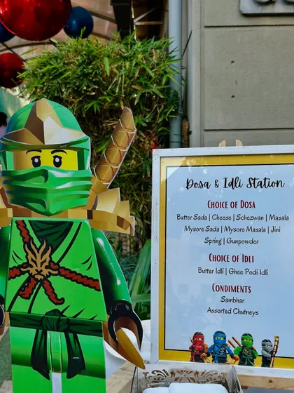 A LEGO Ninjago character stands guard by the Dosa & Idli live station menu. We love incorporating the theme into every aspect of the food setup.