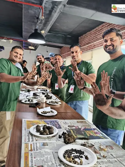 The team showing off their soil-covered hands after the seed ball workshop. This is a sign of a productive and engaging session!