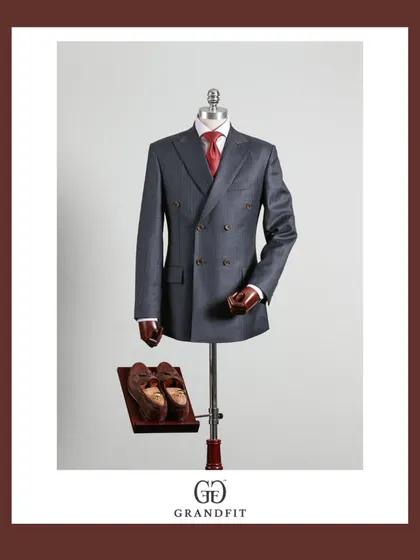 A classic grey double-breasted suit, paired with a bold red tie for a powerful contrast. This is a timeless combination for any formal setting.
