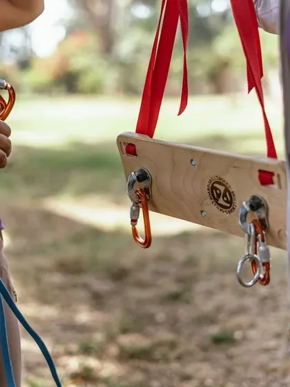A close-up of the Skillzboard, showing how we demonstrate clipping quickdraws and managing the rope. This simple tool makes learning complex skills much more accessible.