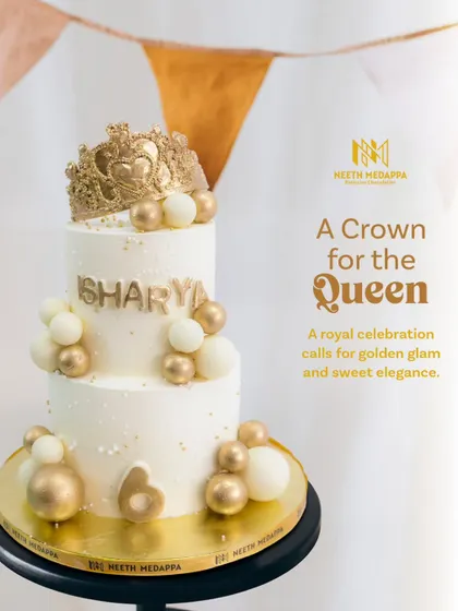 A crown for the queen. This regal two-tiered cake in white and gold is perfect for celebrating a birthday girl of any age.