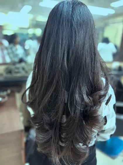 The final result of a long layered haircut, showing beautiful, cascading layers that add texture and shape to the hair.