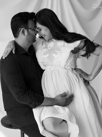 A tender, intimate portrait of a couple awaiting their baby. The black and white tones emphasize the emotion and connection between them.