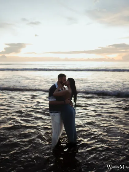 An intimate kiss in the gentle waves of the Phuket sea at dusk. This photo is all about the couple being in their own world, with the ocean as their witness.