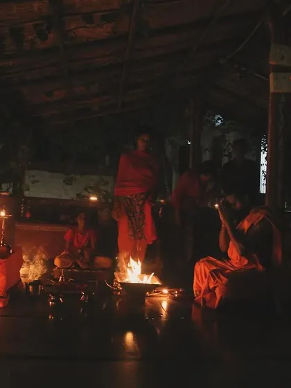 An evening fire ceremony, or 'agnihotra', at the Gurukul. The flickering light of the sacred fire provides a focal point for meditation and prayer, concluding a day of hard training.