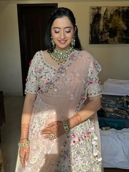 A candid shot capturing the beautiful, dewy finish of her makeup. It's a timeless and elegant look that's perfect for any special occasion.