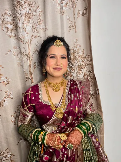 This bride embraced the beauty of another culture for her engagement. Her Marathi-inspired look features a beautiful saree, gold jewellery, and a traditional bindi.