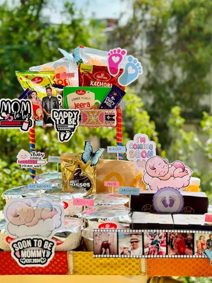 This food hamper is specially designed to satisfy all the cravings of a mom-to-be. It's packed with a variety of snacks, from kachori and dhokla to brownies and chocolates, all personalized for the "soon to be mommy."