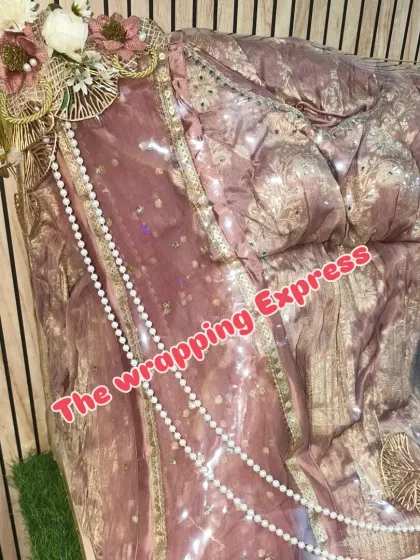 This dusty pink and gold outfit is packed standing up to display its full length and design. It’s a great option for Roka ceremony gifts, making a strong first impression.