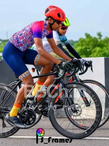 A rider in a colorful jersey stands out against the green backdrop. Our races take you through some of the most beautiful landscapes around Bangalore.