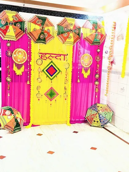 An angled view of the Haldi ceremony backdrop, showing how it creates a bright and festive photo corner in the house.