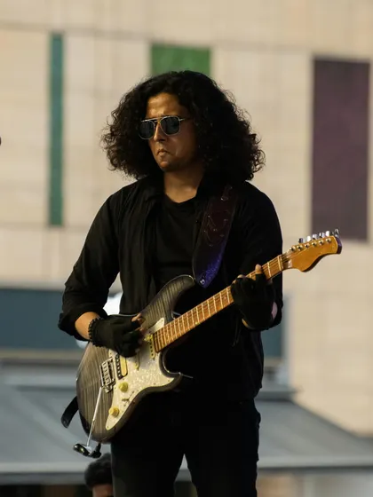 Our lead guitarist focuses on the fretboard between phrases at the Phoenix Marketcity performance.