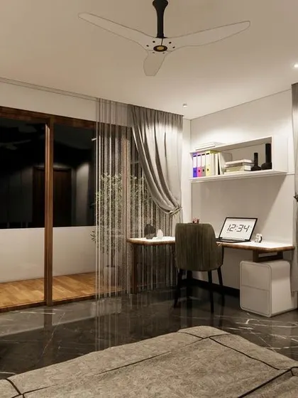 This corner of the bedroom is designed as a functional study nook. The wingback chair offers a comfortable spot for reading, and the large windows are framed with elegant grey curtains.