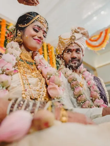 A lovely moment of the couple being showered with blessings during their wedding ceremony.