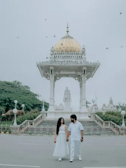 A grand, wide shot of a couple in front of a Mysore landmark, perfect for an epic and memorable pre-wedding photograph.