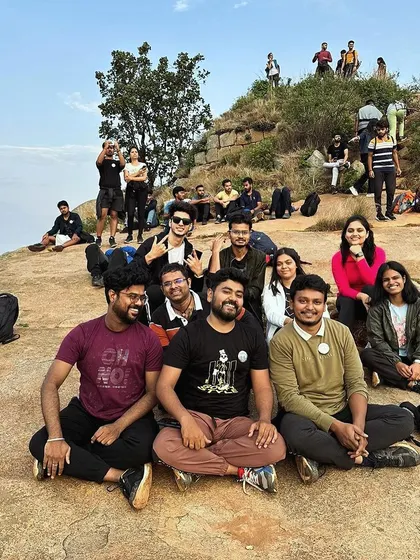 A team relaxing on the rocks at Skandgiri. The informal setting of a trek allows for natural conversations and stronger interpersonal connections.