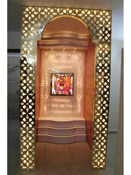 A front view of the mandir room, showing the steps leading up to the altar and the intricate lighting.