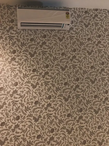 A dense, leafy wallpaper pattern in neutral tones. This type of design adds texture and interest without overwhelming the space.