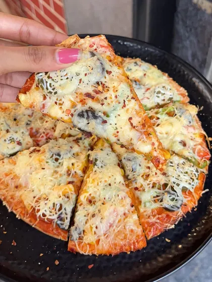 A slice of my All Veg Pizza, showing the crispy crust, fresh vegetables, and melted cheese.