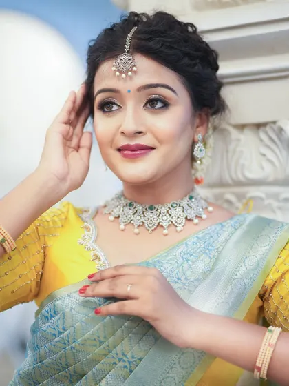 A refreshing combination of a pastel blue silk saree with a vibrant yellow embroidered blouse.