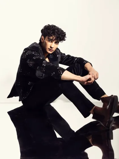 Another angle from the mirrored shoot, showcasing the clean skin finish and well-groomed hair.
