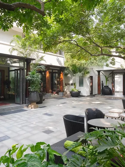 The courtyard of our Golf Links home is an extension of our indoor living space. It has witnessed countless gatherings and performances, shaded by the lush foliage of huge kusum trees, a true urban oasis.