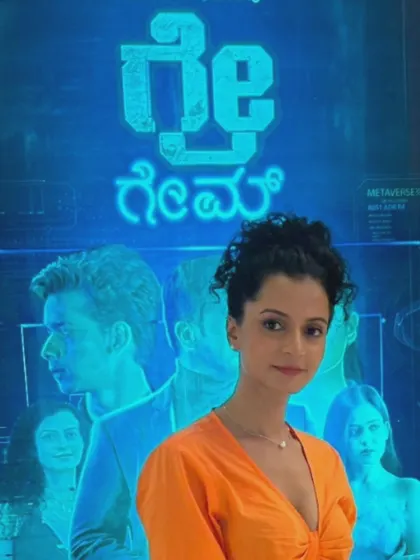 A shot of actress Ishita Singh at her movie premiere, with the movie poster in the background. Her makeup is soft and glowing for the event.