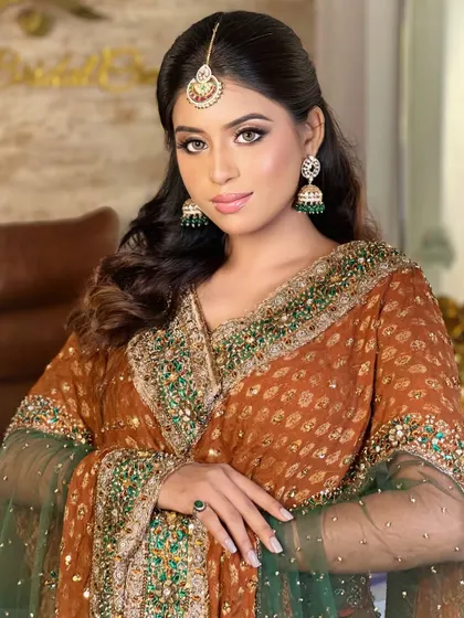 A final portrait of the traditional bridal look. The model's pose showcases the makeup, maang tikka, and earrings, demonstrating how to compose a beautiful shot for a portfolio.