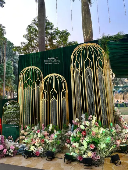 The welcome area at the entrance, with a custom sign and beautiful floral arrangements.