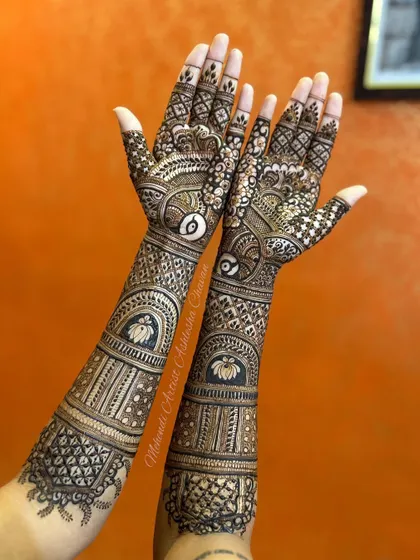 A back-of-the-hand view of a full bridal mehendi. The design features lotus and peacock motifs, creating a stunning look from every angle.