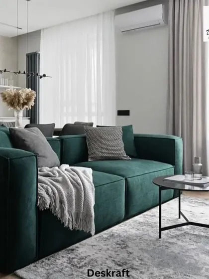 A close-up on the plush green sofa, showcasing its clean lines and comfortable design, perfect for a modern living room that values both style and comfort.