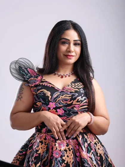 A beautiful portrait featuring a unique floral-patterned gown with a structured shoulder detail, perfect for a fashion-forward look.