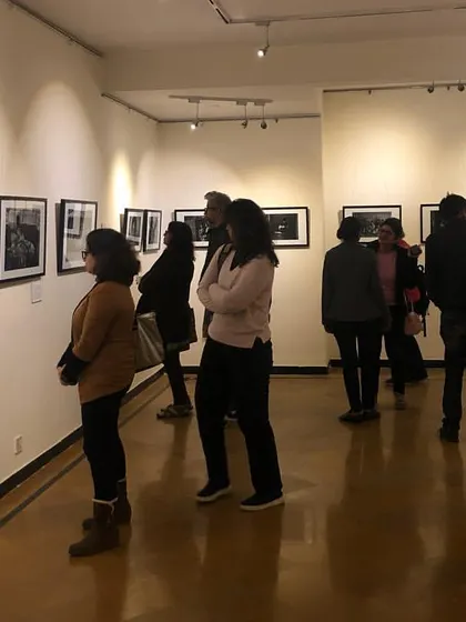 Visitors engaging with the poignant photography at our Gurgaon centre gallery. We create an immersive environment where guests can connect deeply with the stories behind the art.