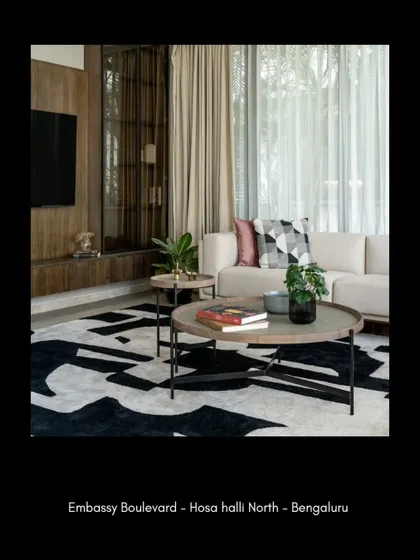 The media unit in the living room combines warm wood with smoked glass, providing elegant storage that feels integrated with the architecture. This piece balances functionality with a refined aesthetic, keeping the focus on the room's overall sense of harmony.